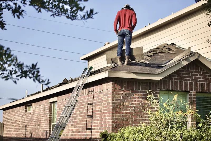 Professional roofer working on a residential roof in Woodberry